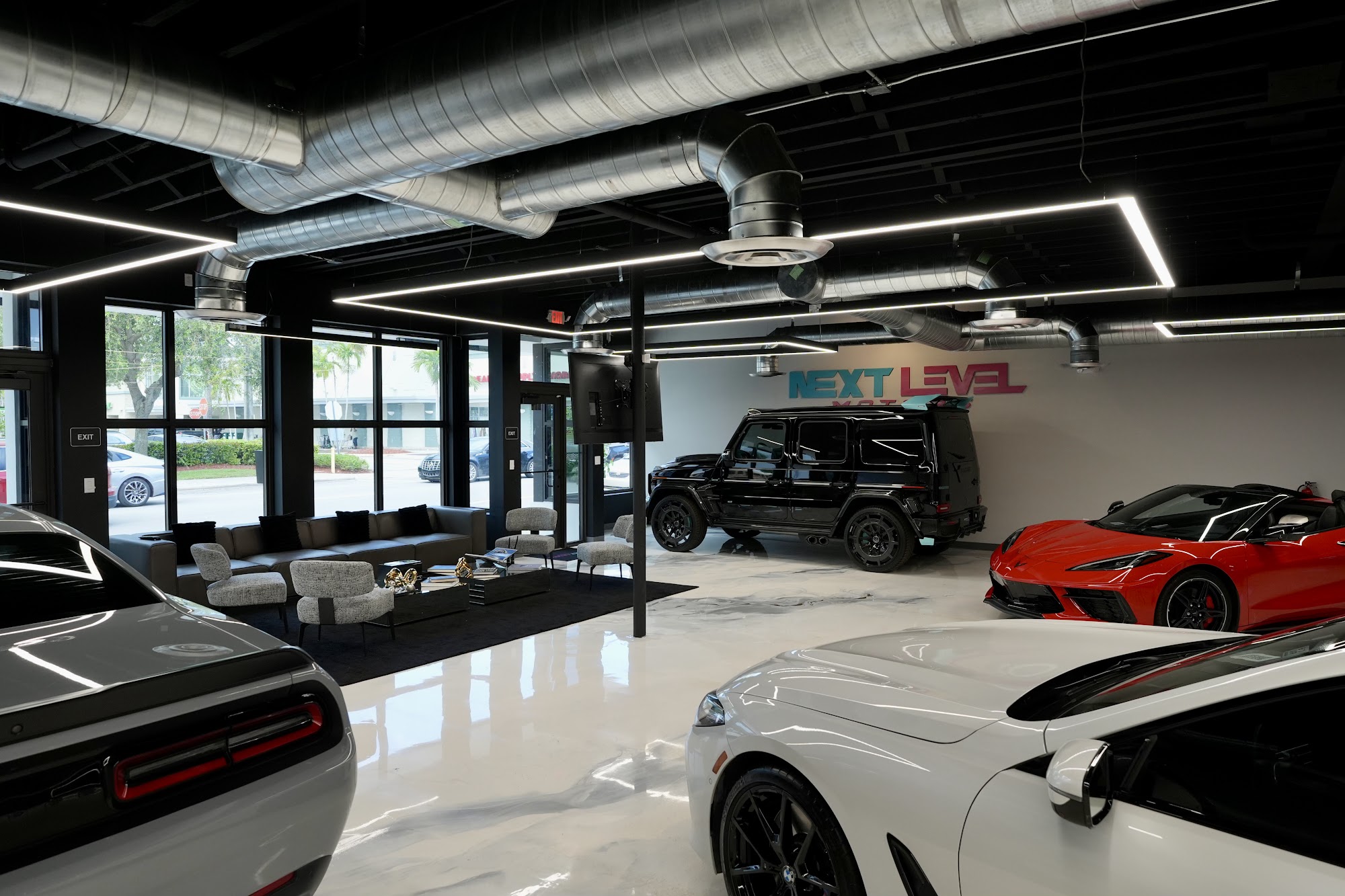 Wide view of the Next Level Motors showroom floor and lounge