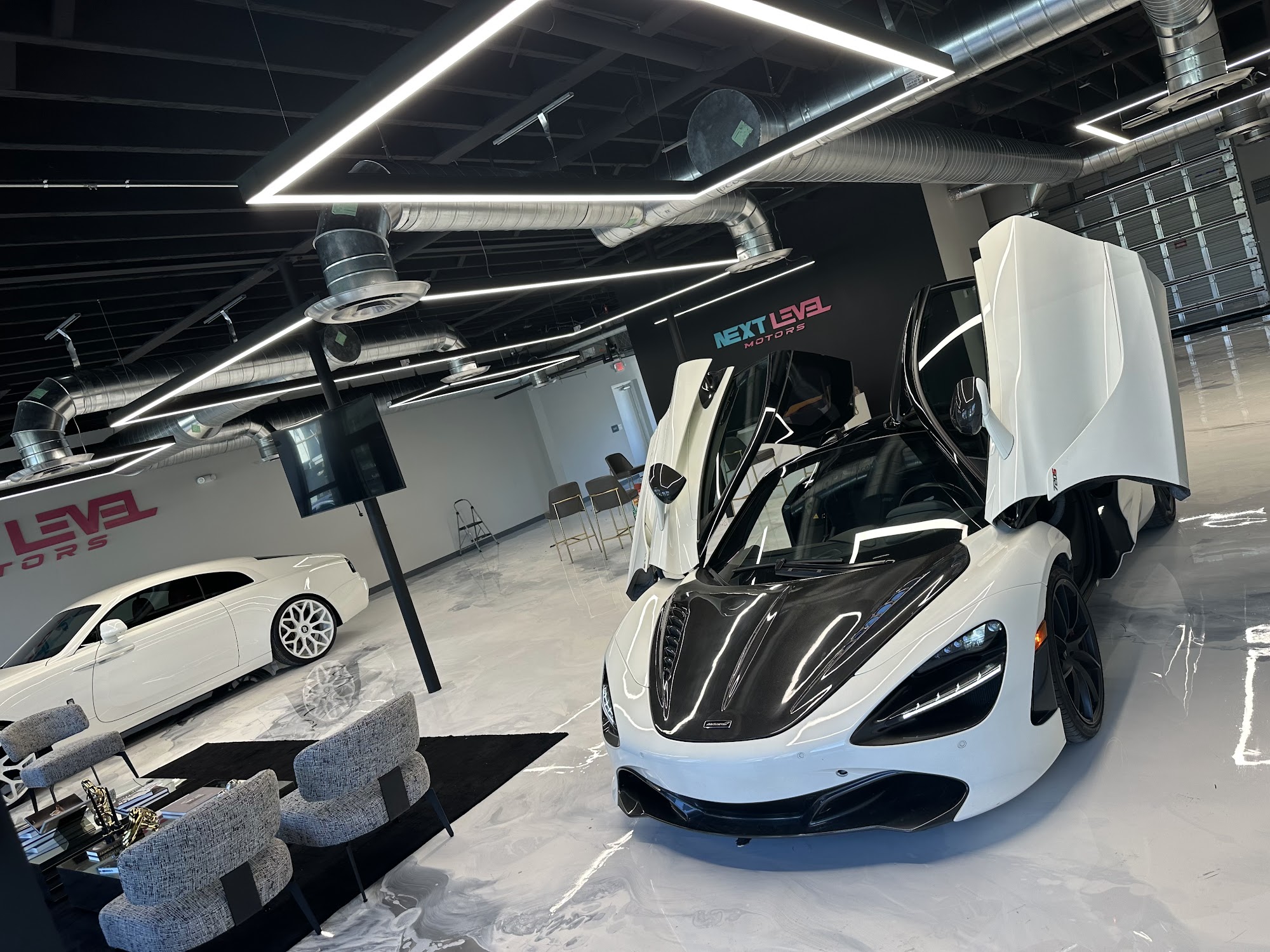 McLaren and Rolls-Royce on the Next Level Motors showroom floor
