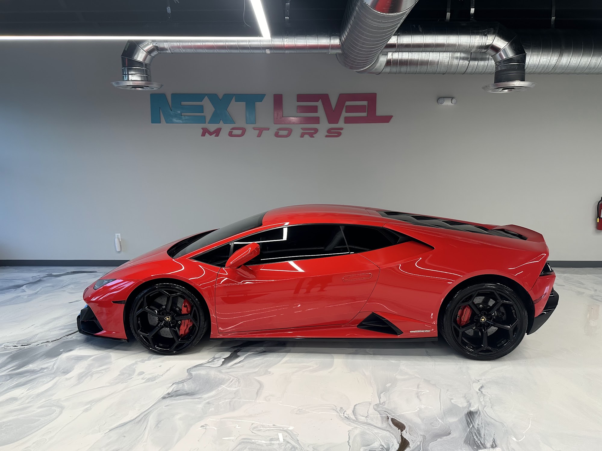 Red Lamborghini Huracán in the Next Level Motors showroom